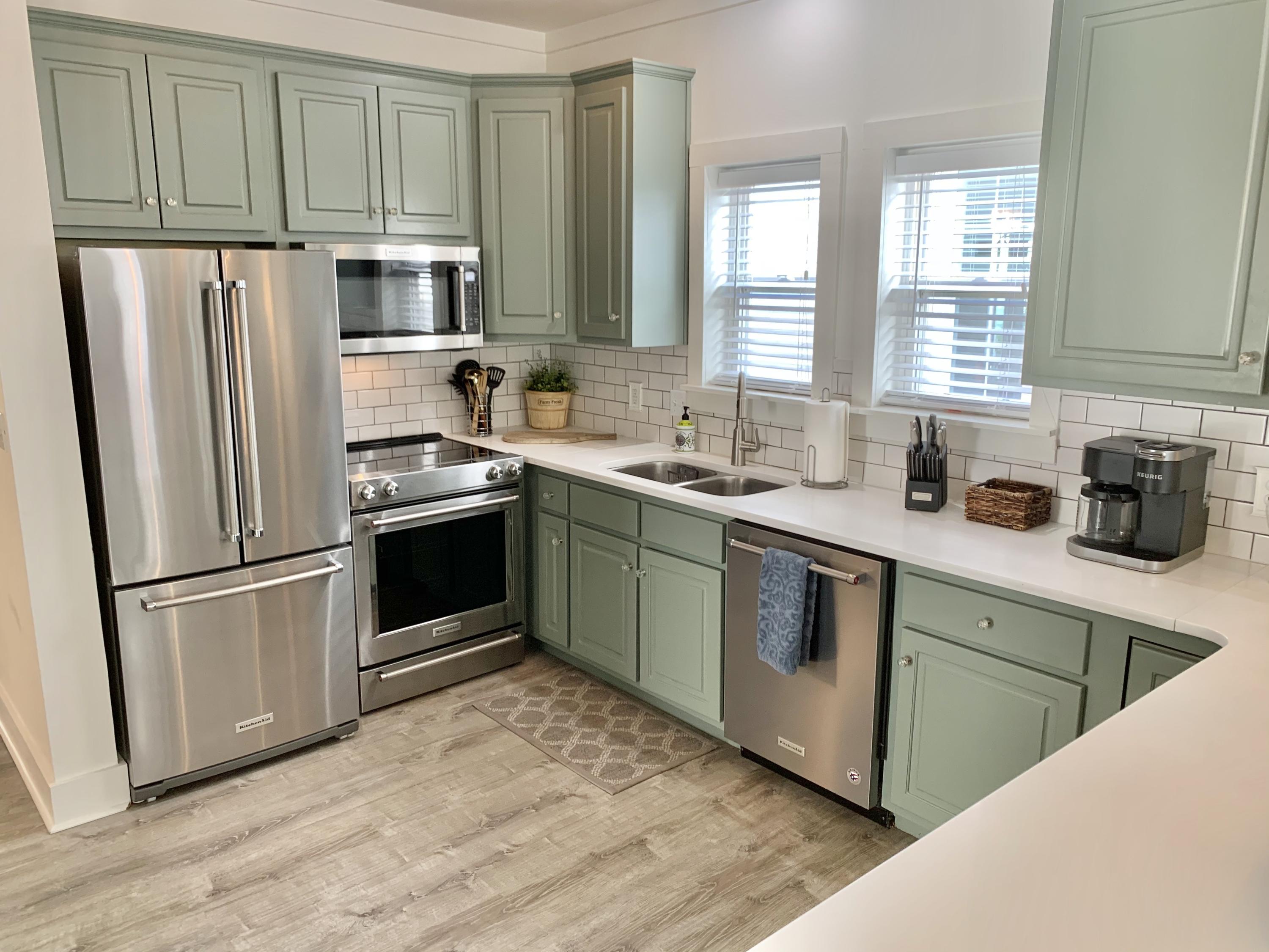 60 The Greenway Loop Inlet Beach, FL 32461 - Photo 15 of 35 a kitchen with stainless steel appliances granite countertop a refrigerator sink and cabinets