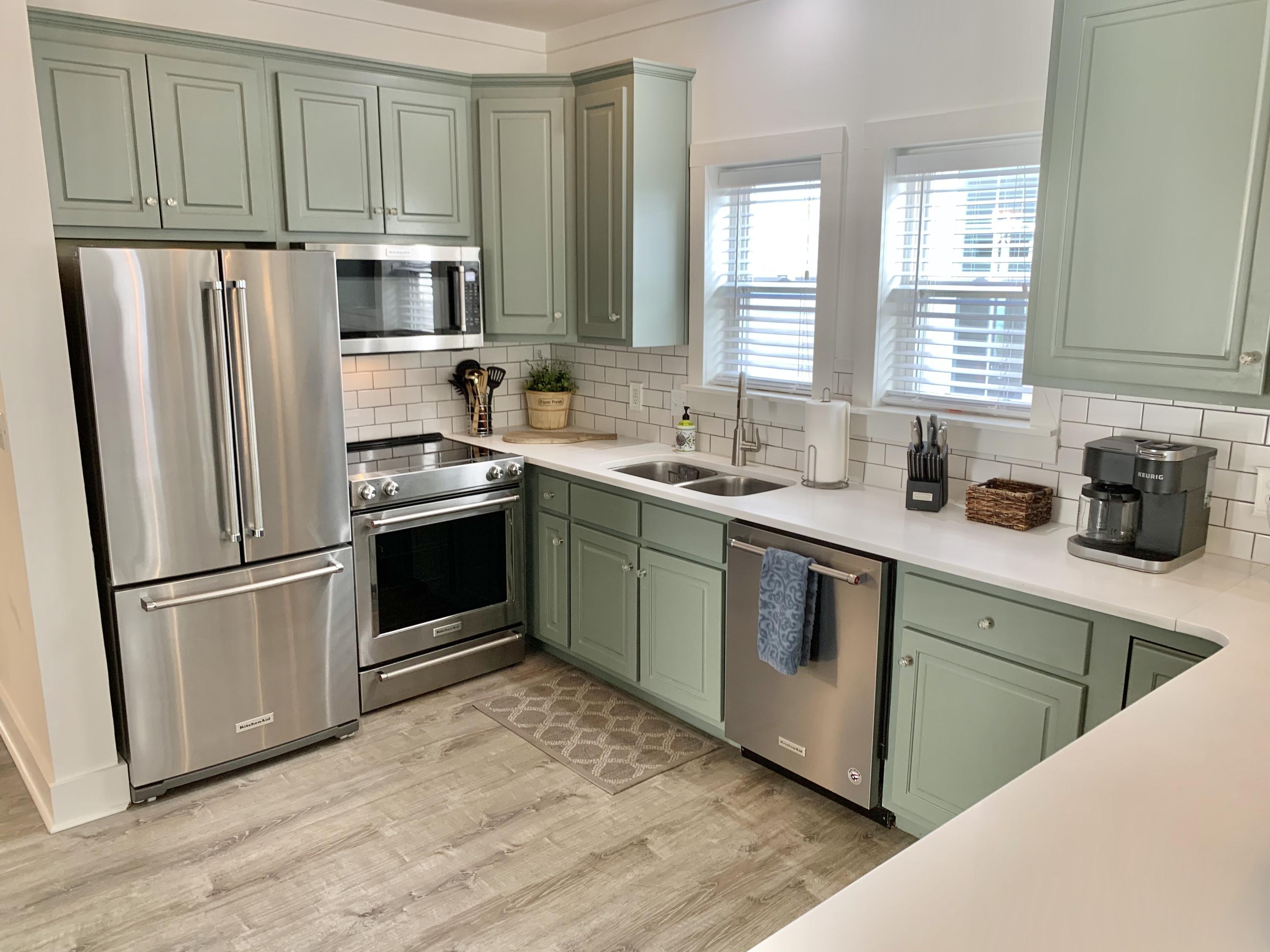60 The Greenway Loop Inlet Beach, FL 32461 - Photo 18 of 35 a kitchen with stainless steel appliances granite countertop a refrigerator sink and cabinets