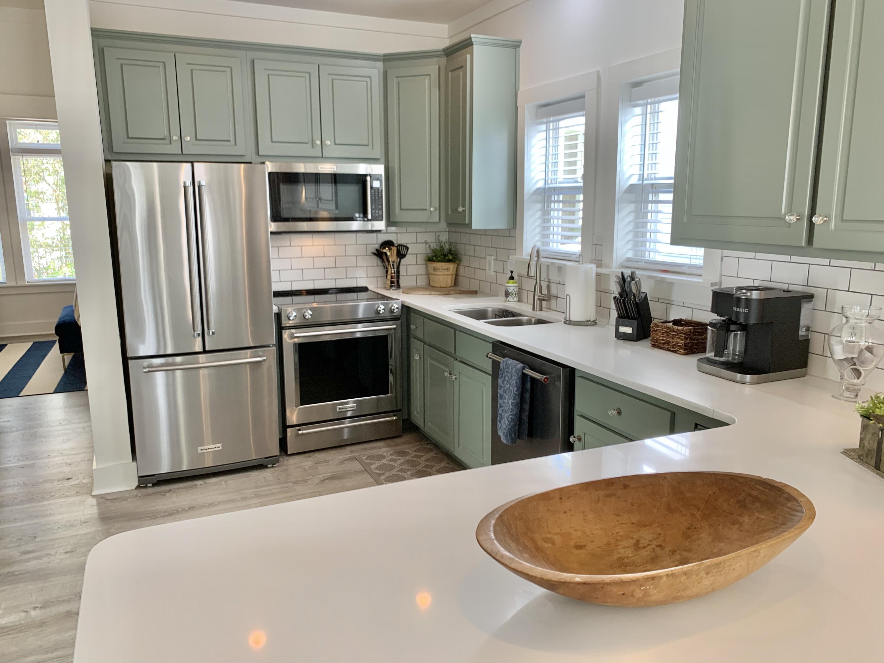 60 The Greenway Loop Inlet Beach, FL 32461 - Photo 20 of 35 a kitchen with stainless steel appliances granite countertop a sink a stove a refrigerator a microwave a counter space and cabinets
