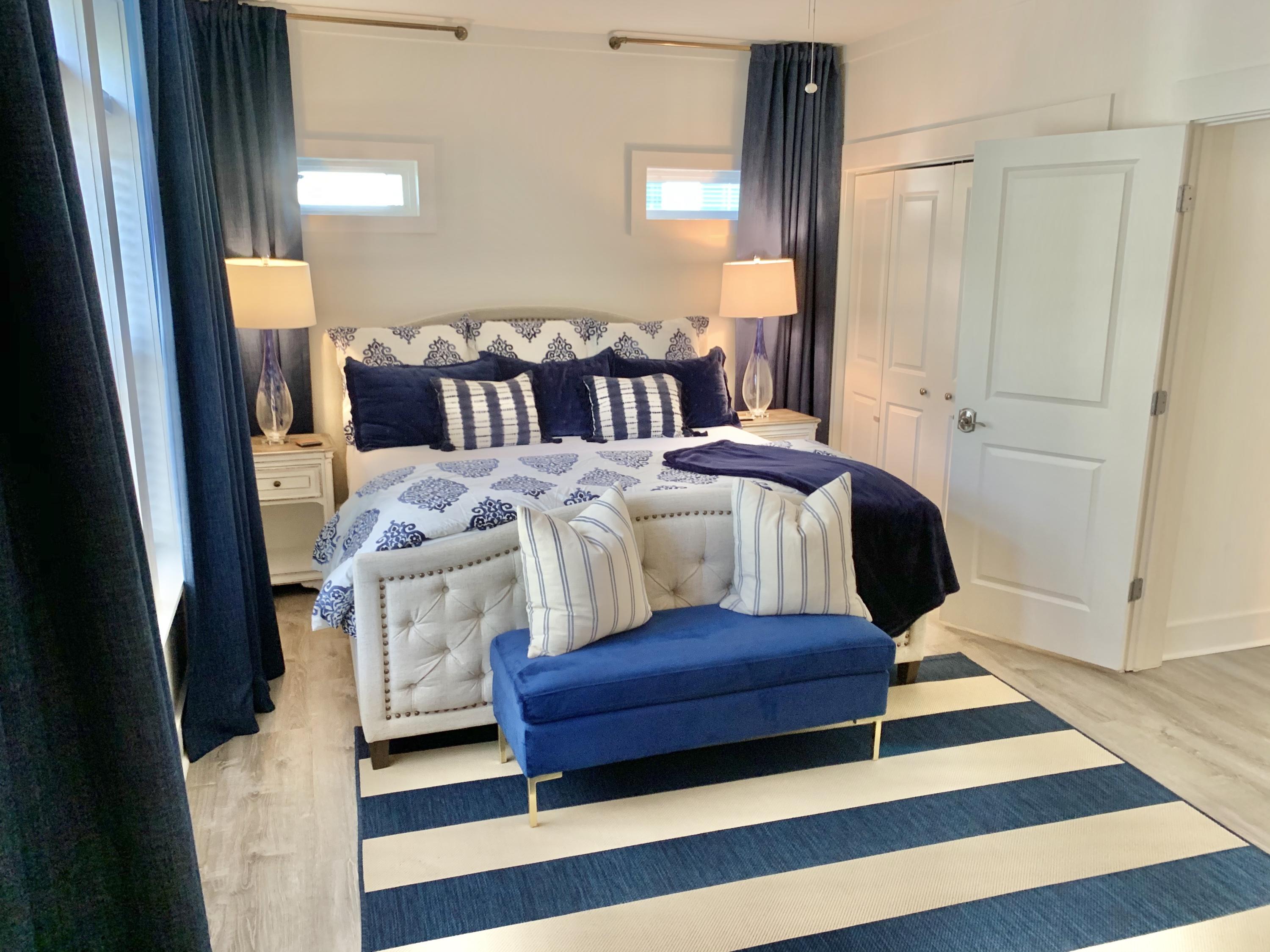 60 The Greenway Loop Inlet Beach, FL 32461 - Photo 24 of 35 a bedroom with a bed and wooden floor