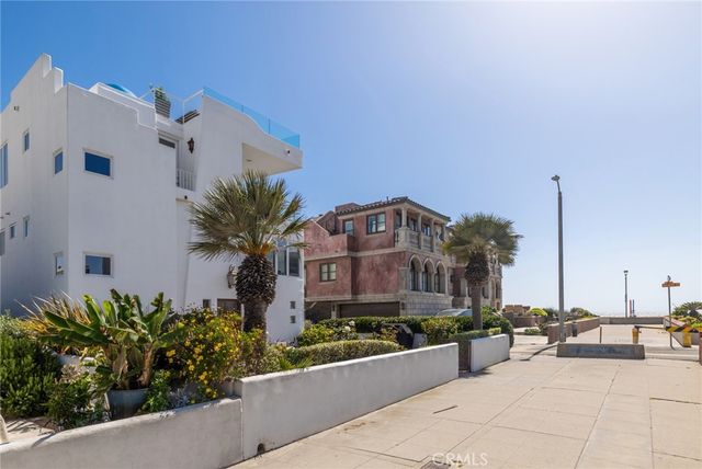a view of a patio with a dining table and chairs under an umbrella
