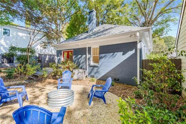 a view of a chairs and table in backyard of the house