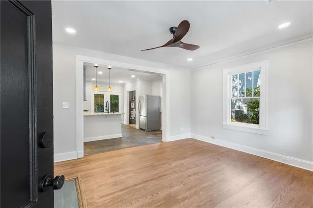 a view of a hallway with a window and wooden floor