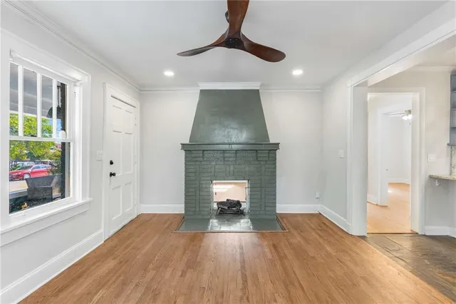 a living room with a fireplace and a wooden floor