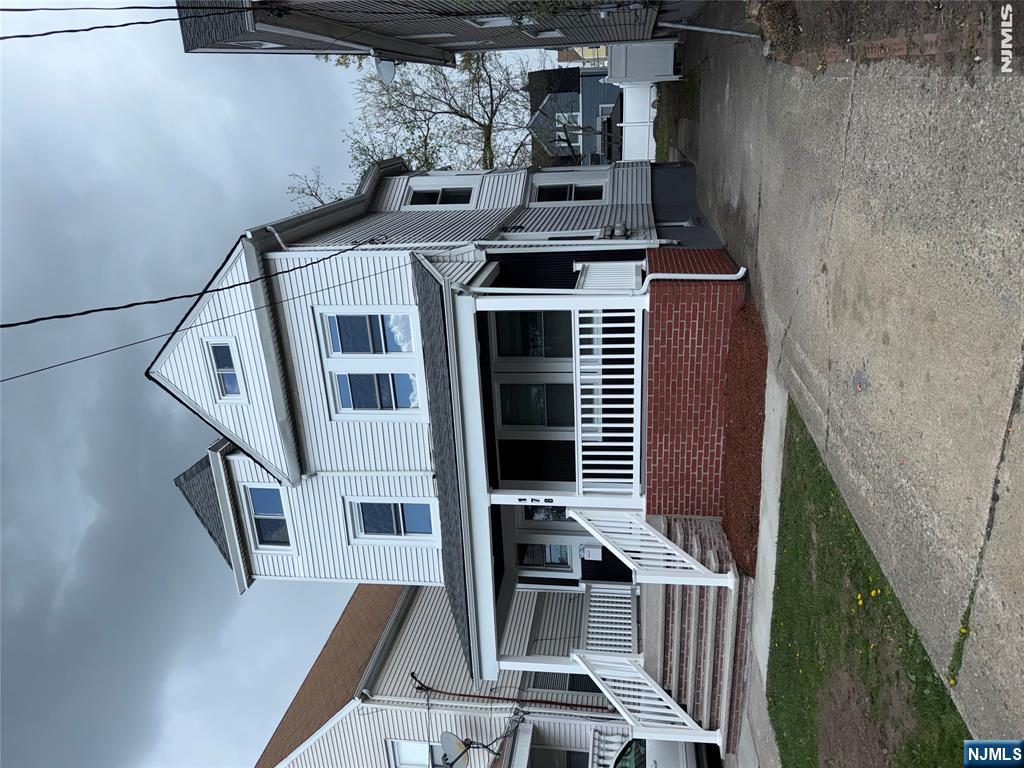 178 Berry Street Hackensack, NJ 07601 - Photo 2 of 22 a front view of a house with a yard