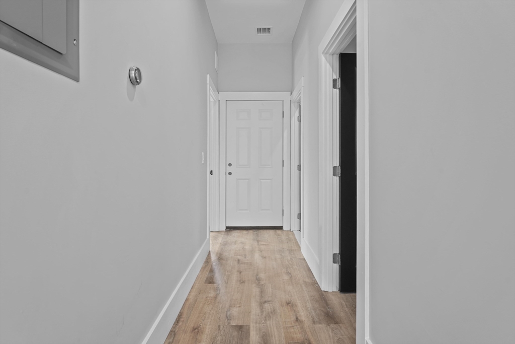 19-21 Standard Street, Unit 3 Boston, MA 02126 - Photo 12 of 23 a view of a hallway with wooden floor