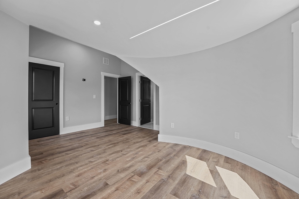 19-21 Standard Street, Unit 3 Boston, MA 02126 - Photo 15 of 23 a view of an empty room with wooden floor