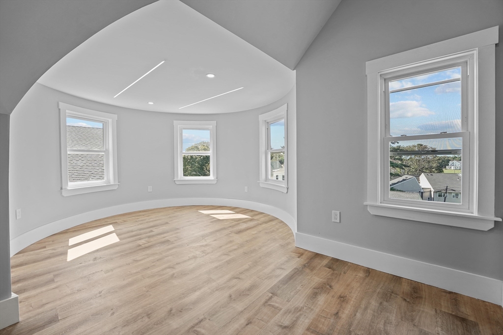 19-21 Standard Street, Unit 3 Boston, MA 02126 - Photo 16 of 23 a view of empty room with wooden floor and fan