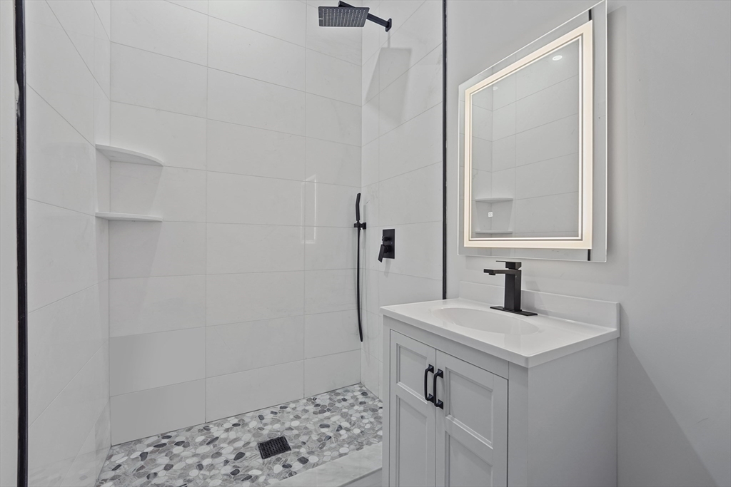 19-21 Standard Street, Unit 3 Boston, MA 02126 - Photo 17 of 23 a bathroom with a sink and a mirror
