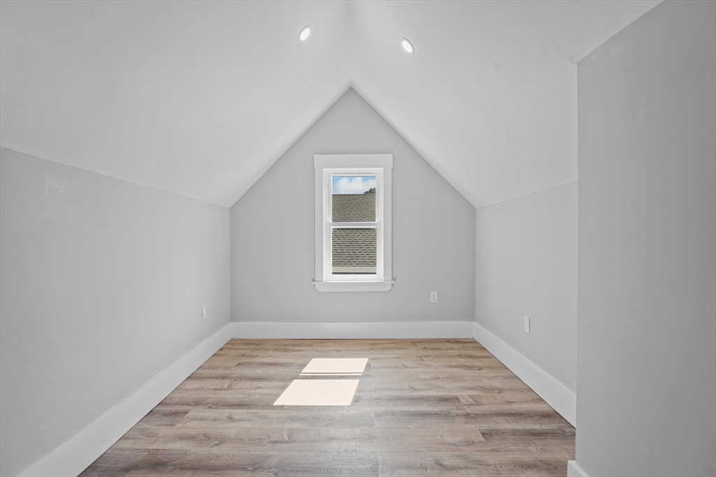 19-21 Standard Street, Unit 3 Boston, MA 02126 - Photo 18 of 23 an empty room with wooden floor and windows