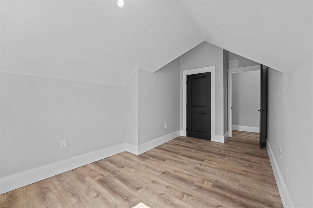 19-21 Standard Street, Unit 3 Boston, MA 02126 - Photo 20 of 23 a view of an empty room with wooden floor