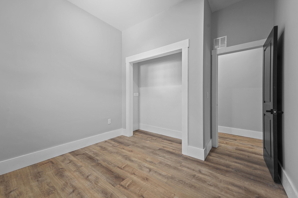 19-21 Standard Street, Unit 3 Boston, MA 02126 - Photo 21 of 23 a view of empty room with wooden floor