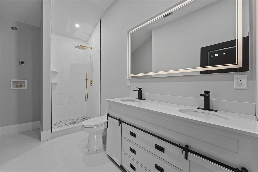19-21 Standard Street, Unit 3 Boston, MA 02126 - Photo 22 of 23 a bathroom with a sink a toilet and shower