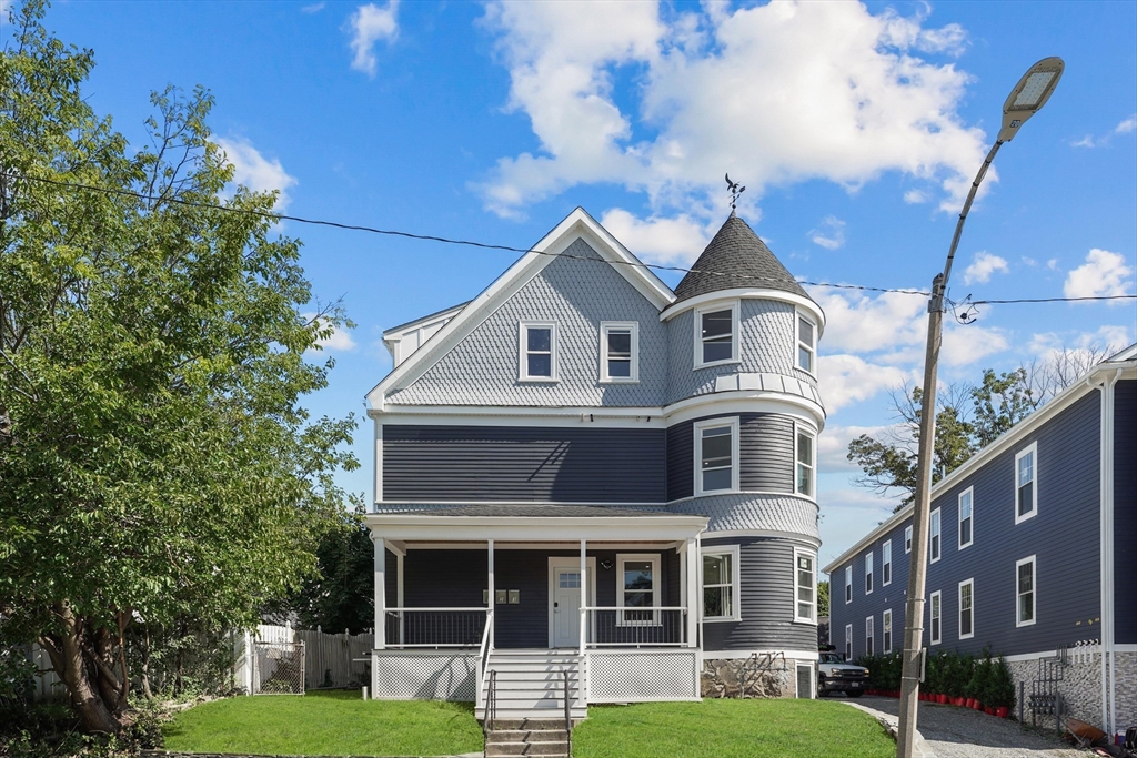 19-21 Standard Street, Unit 3 Boston, MA 02126 - Photo 23 of 23 a front view of a house with a yard