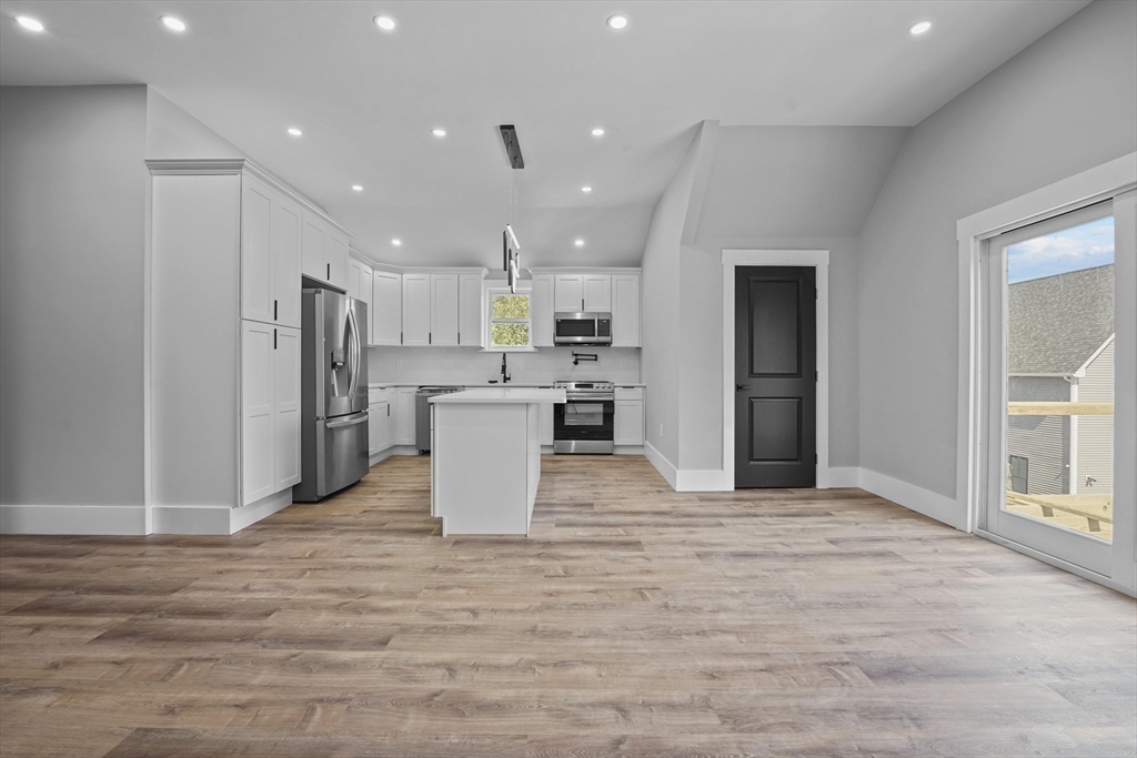 19-21 Standard Street, Unit 3 Boston, MA 02126 - Photo 3 of 23 a view of a kitchen with a refrigerator and a microwave