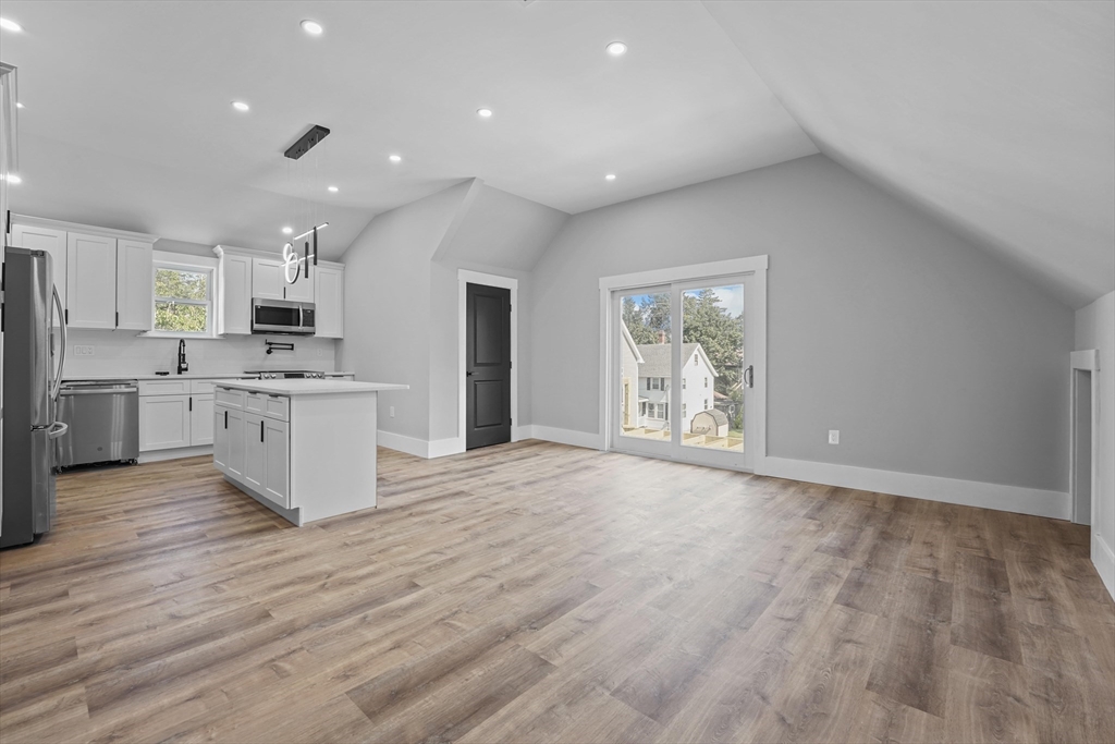 19-21 Standard Street, Unit 3 Boston, MA 02126 - Photo 5 of 23 a large kitchen with stainless steel appliances granite countertop a large counter top and a wooden floors