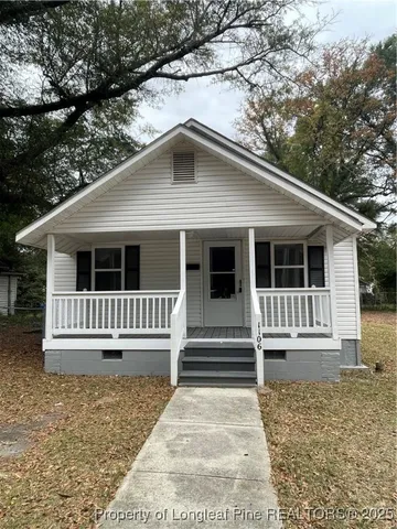 a house with trees in the background