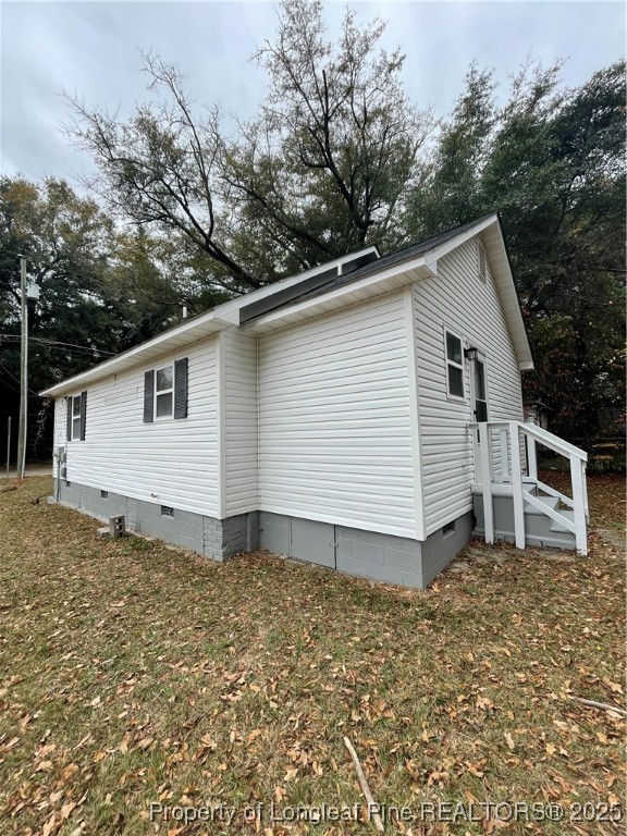 1106 Simpson Street Fayetteville, NC 28305 - Photo 3 of 14 a backyard of a house with large trees