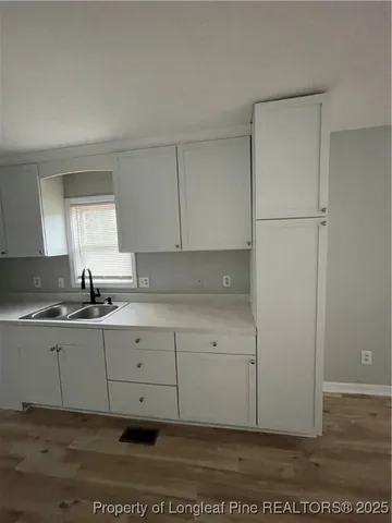 a kitchen with a sink and cabinets