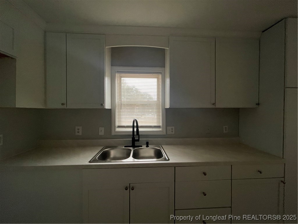 1106 Simpson Street Fayetteville, NC 28305 - Photo 8 of 14 a kitchen with a sink and cabinets