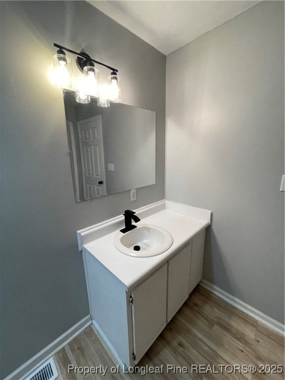 1106 Simpson Street Fayetteville, NC 28305 - Photo 10 of 14 a bathroom with a sink a mirror and vanity
