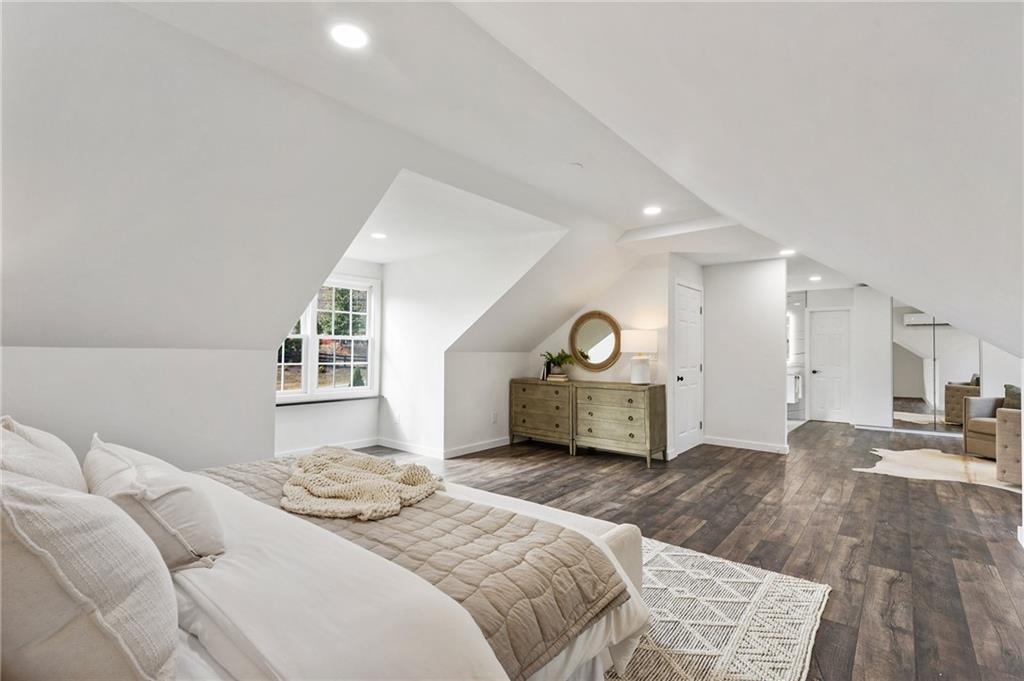14440 Cogburn Road Alpharetta, GA 30004 - Photo 28 of 62 a spacious bedroom with a bed a window and a fireplace