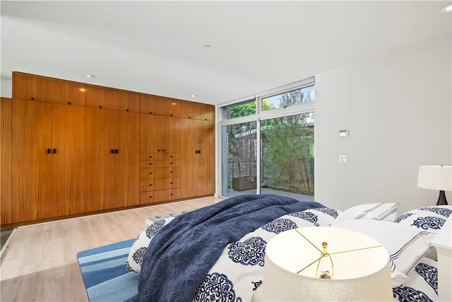 a bedroom with a bed and a large window