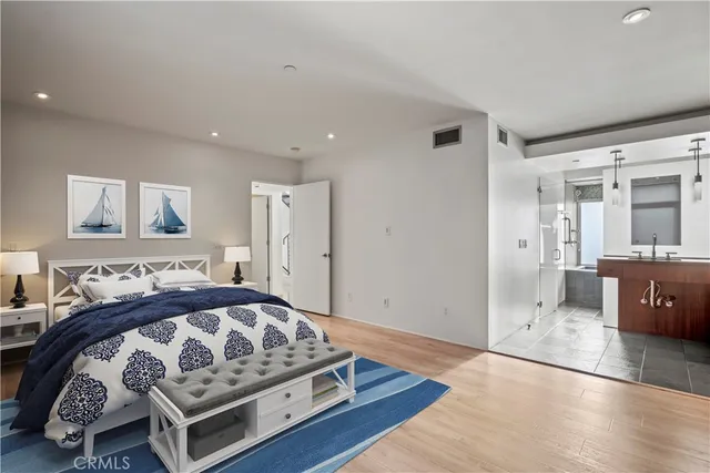 a bedroom with a large bed and a view of living room