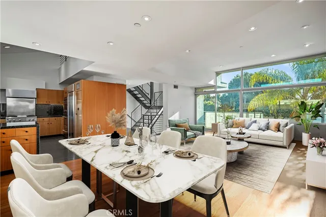 a view of a dining room with furniture large windows and wooden floor