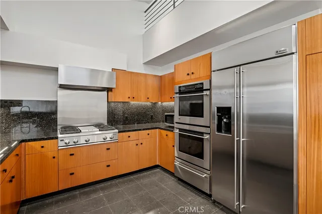 a kitchen with granite countertop stainless steel appliances and counter space
