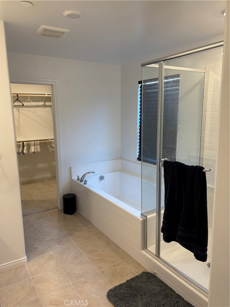 1375 Yeager Avenue Rialto, CA 92376 - Photo 9 of 12 a bathroom with a tub and a shower