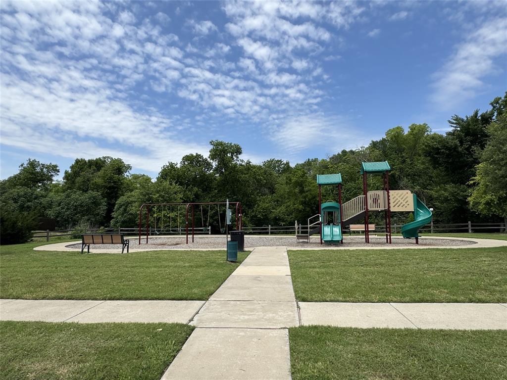 2209 Cinnamon Spgs Road Glenn Heights, TX 75154 - Photo 13 of 28 Community playground featuring a multi-level play structure with slides and swings