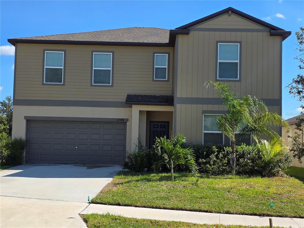 12588 Timber Moss Lane Riverview, FL 33579 - Photo 1 of 10 a front view of a house with a yard
