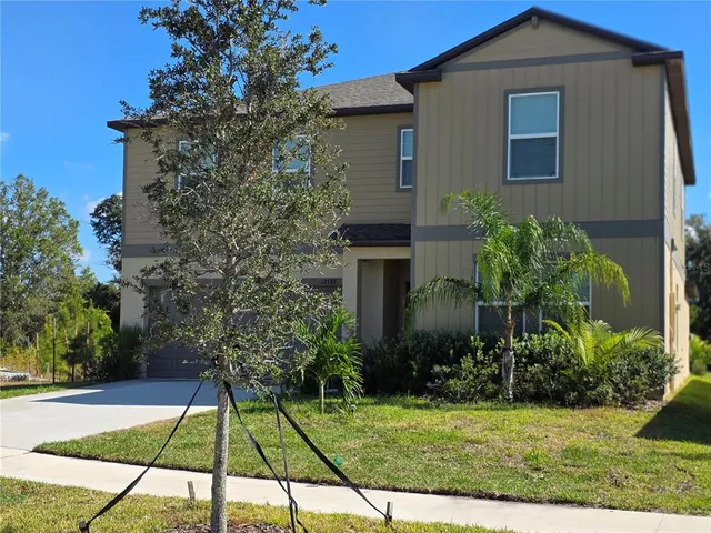 a house that has a tree in front of it