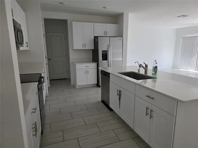 a kitchen with a sink and refrigerator