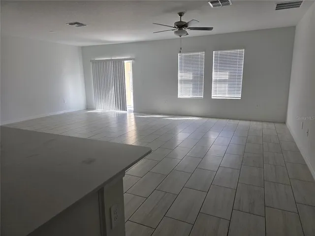 a view of livingroom with hardwood floor and ceiling fan