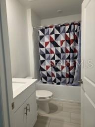 12588 Timber Moss Lane Riverview, FL 33579 - Photo 7 of 10 a bathroom with a toilet and a shower curtain