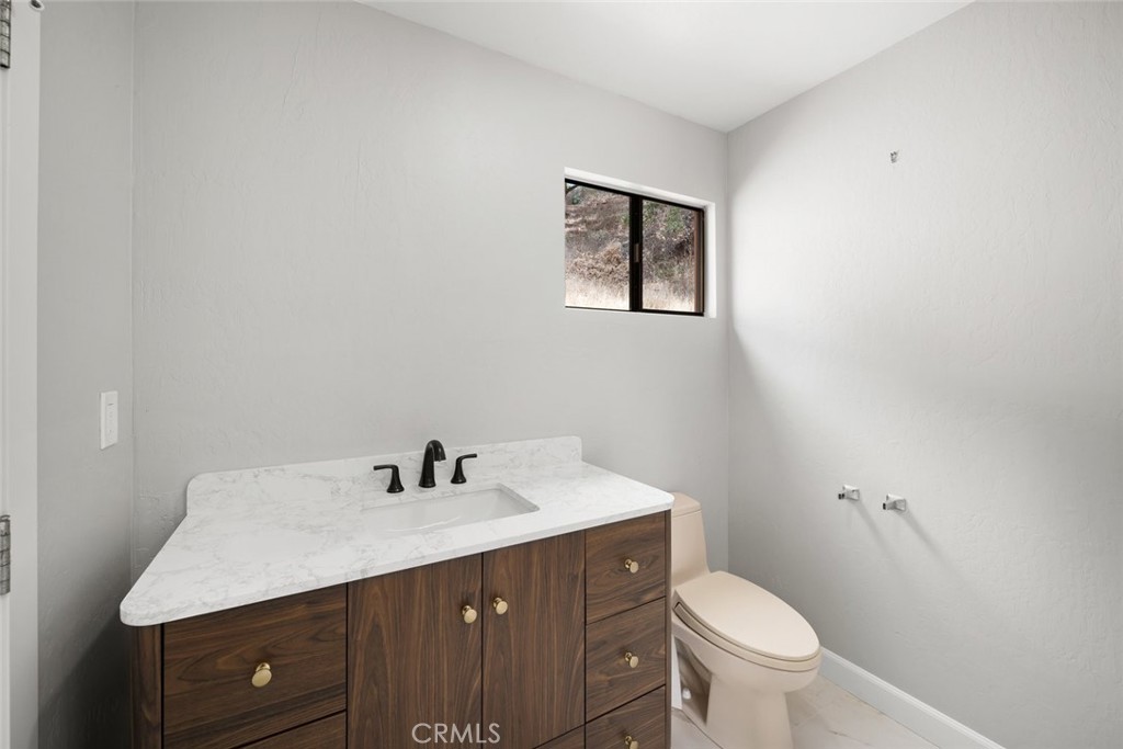 3265 Cypress Mountain Road Templeton, CA 93465 - Photo 19 of 32 a bathroom with a sink vanity and a toilet