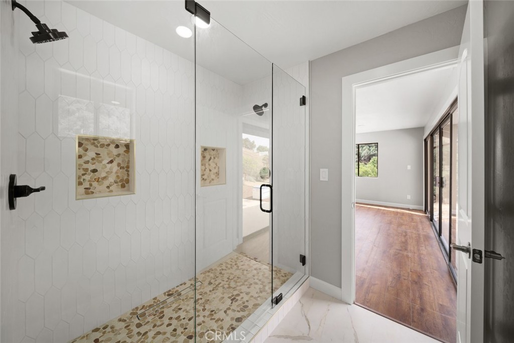 3265 Cypress Mountain Road Templeton, CA 93465 - Photo 20 of 32 a view of a hallway with wooden floor and a bathroom