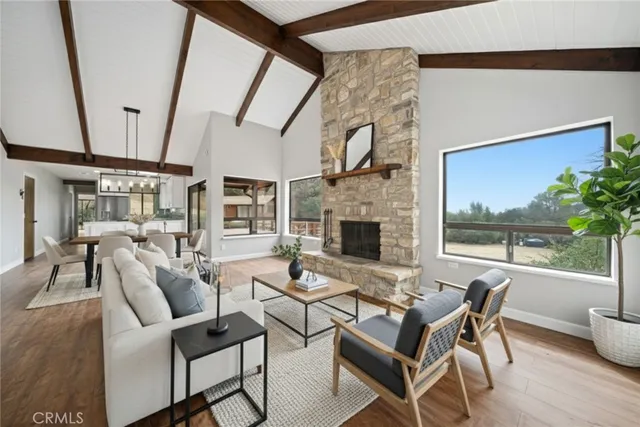 a dining room with furniture and a floor to ceiling window