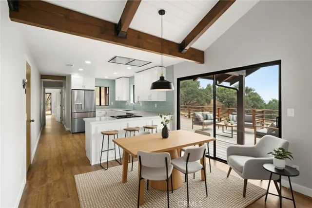 a kitchen with a refrigerator sink and white cabinets