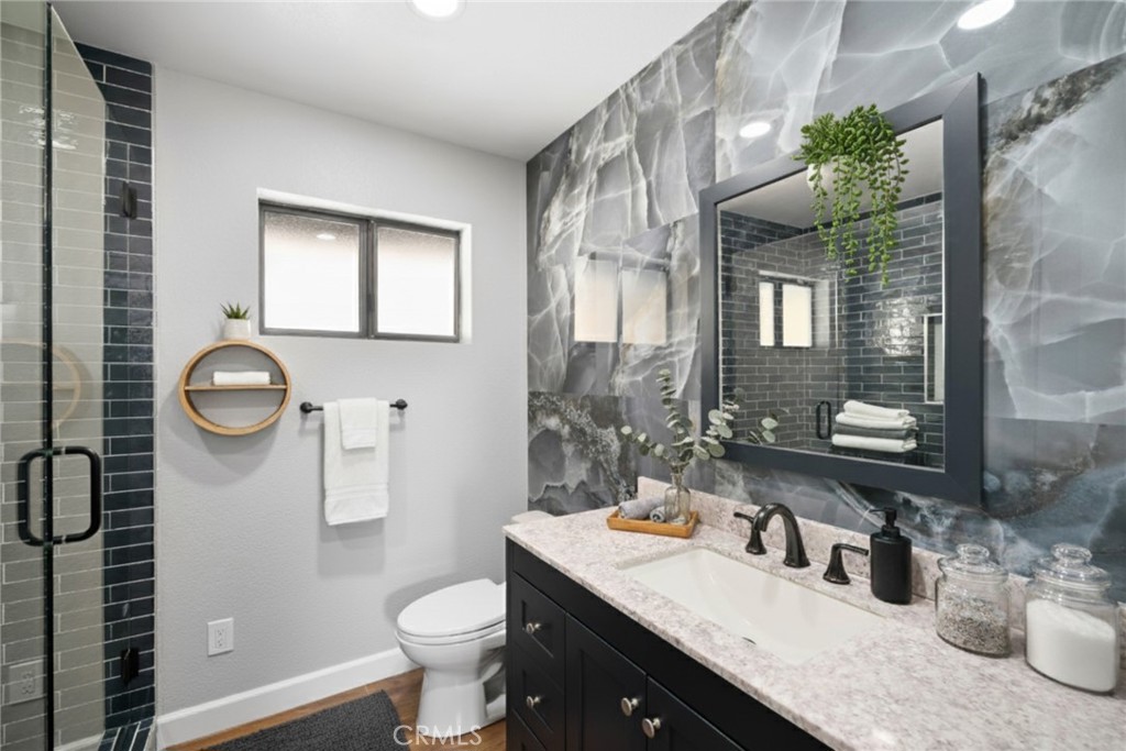 3265 Cypress Mountain Road Templeton, CA 93465 - Photo 10 of 32 a bathroom with a sink a toilet a mirror and shower
