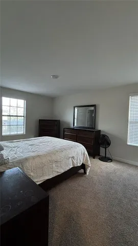 a bedroom with a bed and window