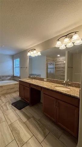 a large bathroom with a sink and a large mirror