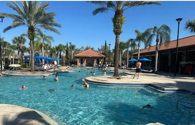 a view of a house with backyard and sitting area