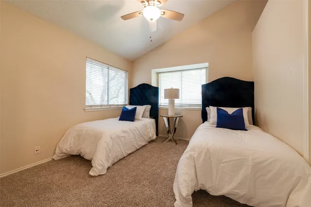 a bedroom with bed and a chandelier