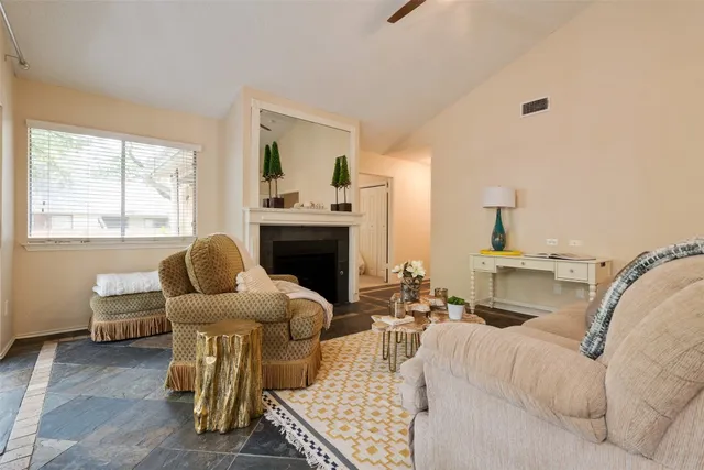 a living room with furniture fireplace and window