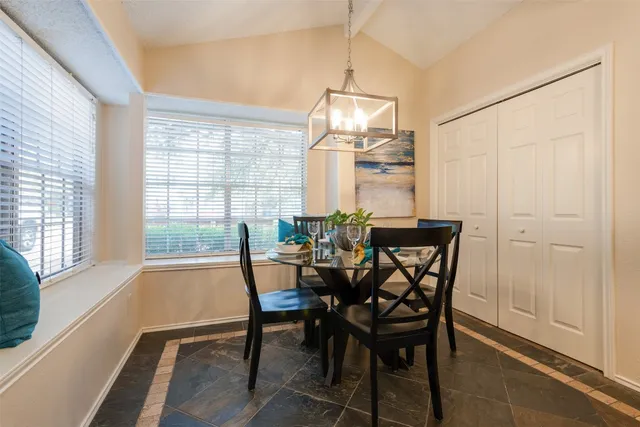 a dining room with furniture and window