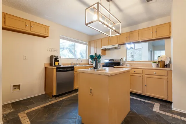a kitchen with sink cabinets and window