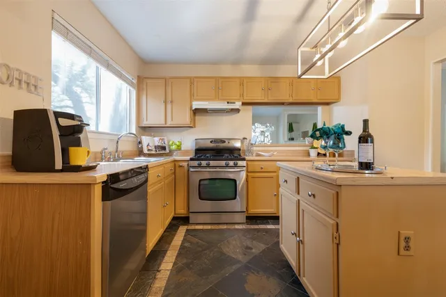 a kitchen with a stove a sink and a microwave